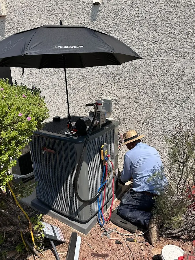 HVAC technician performing outdoor AC maintenance in Joppatowne